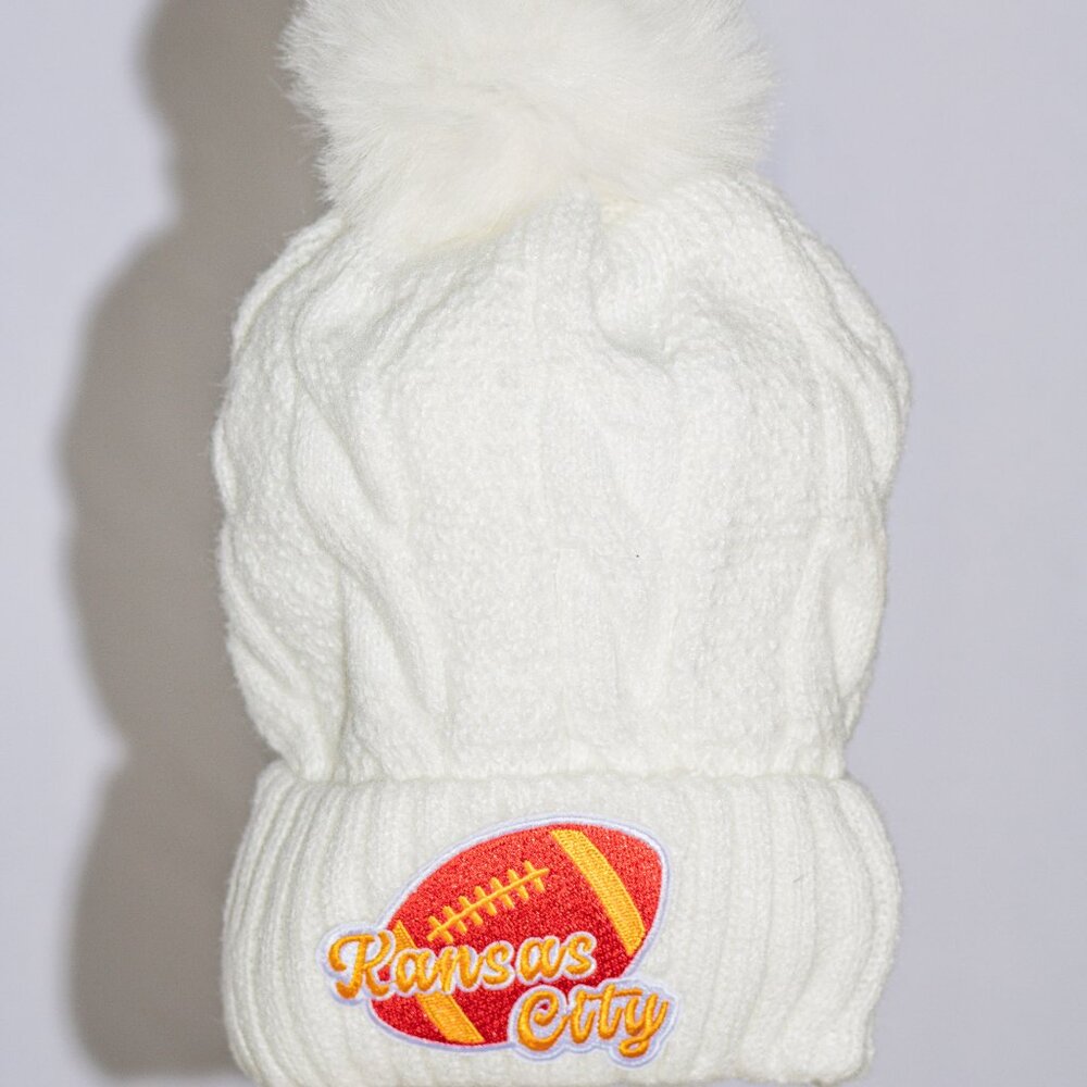 White stocking cap with K C Chiefs patches and fuzzy lining